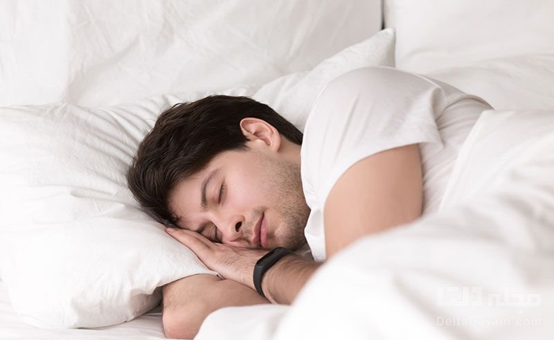 young guy sleeping in bed wearing smartwatch or sleep tracker 800x491 1